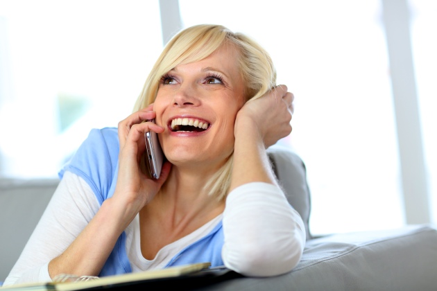 Beautiful blond woman laughing on the phone