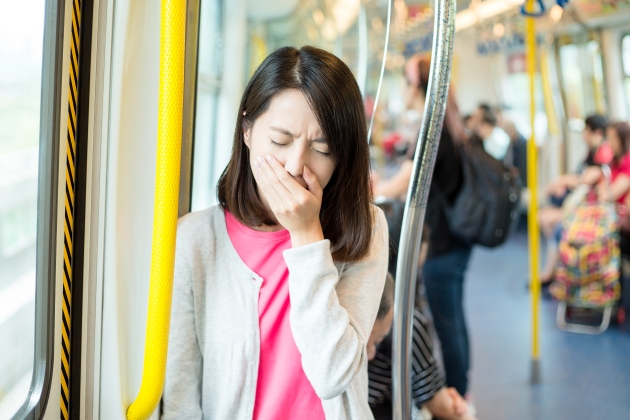 Woman getting sick in train compartment